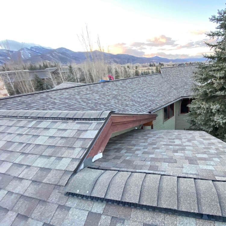 Complex roofline with mountain sunset